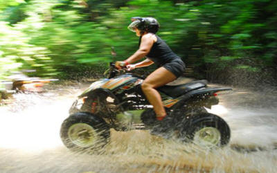 ATV riders exploring rainforest trails with river crossings and mountain views in Costa Rica - Macaws Adventure Tours by Pablo C