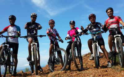 Mountain biker riding scenic trail with Arenal Volcano view and Costa Rican rainforest scenery - Macaws Adventure Tours by Pablo C