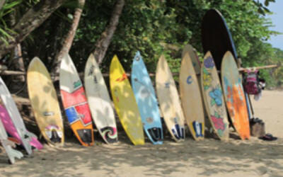 Instructor teaching surf lesson on Costa Rican Pacific beach with beginner waves and beautiful coastline - Macaws Adventure Tours by Pablo C
