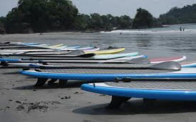 Stand up paddleboarding on calm Costa Rican coastal waters with beautiful beach and mountain views - Macaws Adventure Tours by Pablo C