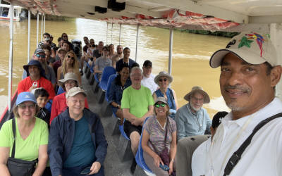 Wildlife boat tour through Tortuguero Canals with monkeys, sloths, and tropical birds visible in jungle - Macaws Adventure Tours by Pablo C